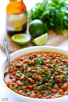 a white bowl filled with beans and cilantro