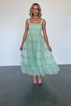 Dreamy tulle maxi for parties, photoshoots, and more Soft minty sage green Straight neckline Smocked bodice Tank strap sleeves Tulle maxi skirt with ruffled tiers Two layers of tulle for volume Skirt is fully lined Self and Lining: 100% Polyester Trina is 5'6, cup size 32D, size 2 and is wearing size S Summer Tulle Dress With Ruched Details, Spring Party Maxi Dress With Smocked Bodice, Summer Prom Maxi Dress With Tiered Skirt, Spring Tulle Maxi Dress With Ruffles, Green Spring Maxi Dress For Prom, Spring Tiered Maxi Dress For Prom, Spring Prom Tiered Maxi Dress, Spring Bridesmaid Ruched Maxi Dress, Ruched Maxi Dress For Spring Bridesmaid