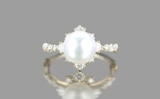 a white pearl and diamond ring