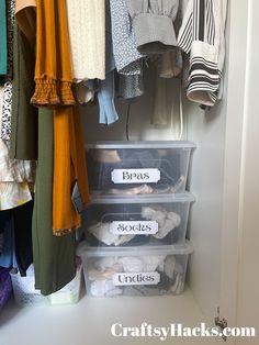 an organized closet with plastic bins and clothes