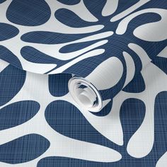 a blue and white wallpaper with an abstract design on the back side of it