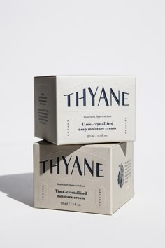 two boxes of thyane soap sitting side by side on a white surface with shadows