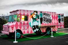 an ice cream truck is painted pink and has a woman's face on the side