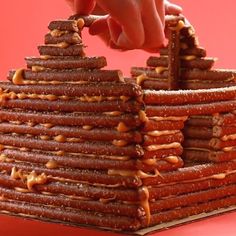 a stack of pretzels being held by a person's hand over the top