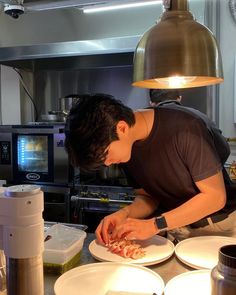 a man is preparing food in the kitchen