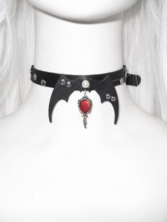 Elevate your alternative fashion game with this uniquely designed choker. Adorned with edgy stud embellishments, this piece stands out with its striking bat wing accents, adding a touch of dark allure to your ensemble. The choker also features a mirror pendant, offering both a functional and decorative element. Perfect for those who love to blend gothic and kawaii aesthetics, this choker is a must-have accessory for your collection.  The price is for one choker only. Punk Choker, Punk Skirt, Gothic Bag, Heart Shaped Bag, Casual Goth, Mirror Pendant, Gothic Tops, Gothic Shoes, Punk Dress