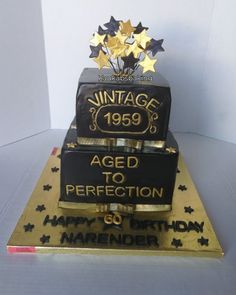 a black and gold 50th birthday cake with stars on the top that says aged to perfection