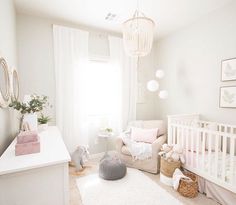 a baby's room with a crib, rocking chair and white rugs