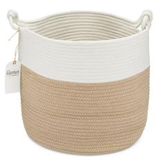 a large white and tan basket with rope on the bottom, sitting in front of a white background