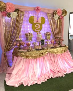 a pink and gold minnie mouse dessert table