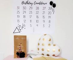 a birthday calendar is hanging on the wall next to a teddy bear and other items