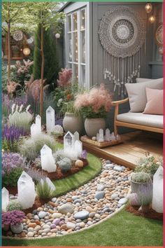 an outdoor garden with rocks, plants and stones on the ground in front of a house