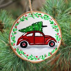 a christmas ornament with a red car carrying a tree