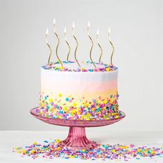 a birthday cake with sprinkles and candles