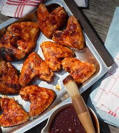 chicken wings and dipping sauce on a tray