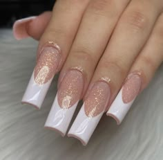 a woman's hand with pink and gold nail polish on it, holding onto her nails