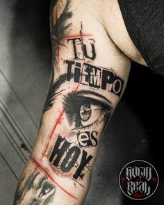 a man's arm with an eye and words tattooed on the side of it