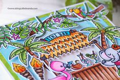 a close up of a card with animals and palm trees