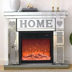 an electric fireplace with the word home painted on it's front and side panels