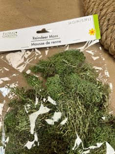 a package of green moss sitting on top of a table