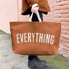 Our best-selling Everything oversized tote bag, in beautiful tan canvas! These extra large canvas totes are REALLY useful. Perfect for parents, students, teachers, and anyone else who finds themself carrying ALL the things! Our EVERYTHING bag has been made from thick tan canvas, screen printed by hand big and bold. Designed in our studio in Saffron Walden and lovingly handmade in the UK using exceptionally fine materials. * Made in the UK * 15oz thick tan canvas * Deep flat base * Screen printed in off-white * Mid-length handles * 730mm by 440mm by 170mm (28¾ by 17½ by 6¾ inches) Extra Large Tote Bags, Canvas Grocery Bag, Saffron Walden, Canvas Totes, Extra Large Canvas, Oversized Tote Bag, Oversized Tote, Big Bag, Changing Bag