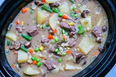 a close up of a bowl of food with meat and vegetables