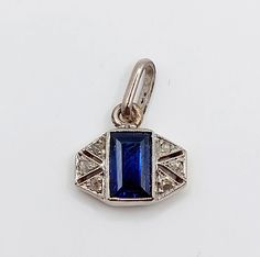 French art deco pendant 18k white gold set with a synthetic sapphire shouldered with rose cut diamonds in a geometric setting (circa 1920)  Magnificent antique French work (transformation of an old pin into a pendant)  Size: 15 x 10 mm (with bail) PLEASE NOTE SMALL SIZE  Weight: 1.02g  Sapphire size: 6 x 4 mm  Hallmarks erased by the transformation Visit my shop for even more antique jewelry: https://www.etsy.com/shop/AugustusJewels Art Deco Sapphire Jewelry With Diamond Accents, Sapphire Art Deco Jewelry With 17 Jewels, Art Deco Sapphire Jewelry With 17 Jewels, Art Deco Sapphire Jewelry In White Gold, White Gold Sapphire Art Deco Jewelry, Art Deco White Gold Sapphire Jewelry, Art Deco Sapphire Sterling Silver Jewelry, Sapphire Sterling Silver Art Deco Jewelry, Art Deco Sapphire Hallmarked Jewelry