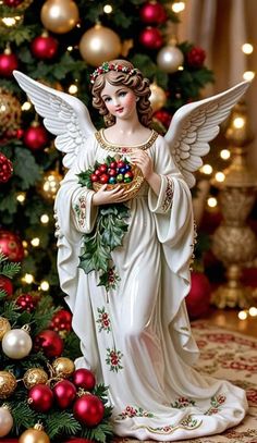 an angel statue next to a christmas tree