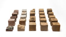 several blocks of clay are arranged on a white surface, including one brick and the other block