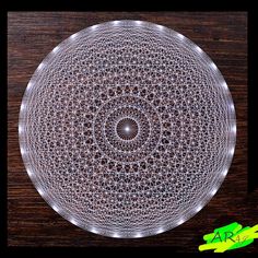 an intricately designed glass plate sitting on top of a wooden table