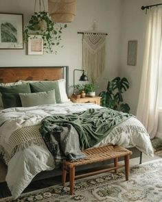 a bedroom with a bed, rugs and plants on the wall in front of it