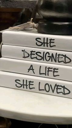 four books stacked on top of each other with the words she designed a life she loved