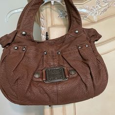 Kathy Van Zeeland Hobo Style Bag In Cappucino. Has Multiple Pockets In And Out. Two Roomy Inside Compartments And A Zippered Middle Pocket. Very Roomy. Brown Satchel With Pockets For Fall, Brown Fall Satchel With Pockets, Casual Satchel With Metal Hardware Tote Shape, Casual Tote Satchel With Metal Hardware, Casual Satchel Tote With Metal Hardware, Brown Casual Satchel With Snap Closure, Casual Brown Satchel With Snap Closure, Kathy Van Zeeland Handbags, Hobo Tote Bag