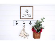 two ice skates are hanging on the wall next to a basket with flowers