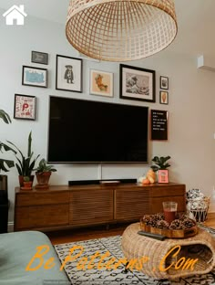 a living room filled with furniture and a flat screen tv mounted to the side of a wall