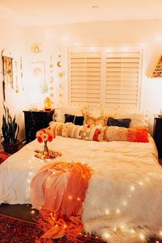 a bed with white fur and lights on it