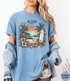 Discover our Hawaii Aloha Vintage Comfort Colors shirt! This cute t-shirt features an eye-catching design with a vintage graphic of a tropical island and retro sunset. Made of 100% ring-spun ethically grown cotton, this shirt is super soft and comfortable. It has a relaxed fit which is made of a medium fabric that is preshrunk. Looks super cute with shorts or jeans and throw a cardigan on top for that cooler evening.Size up 1-3 sizes for an oversized beach coverup. Great gift for a BeachLover! Comes in 13 pretty colors! 💠PRINT: This is a handmade, Direct-to-Garment printed item. The designs are professionally printed directly on to the shirt. All over printing is used. The ink is printed directly into the fabric. ✦Images may sometimes appear larger in the photo than in person due to image Vintage Printed T-shirt For Vacation, Hawaiian Shirt With Letter Print, Hawaiian Short Sleeve Shirt With Letter Print, Casual Hawaiian Shirt With Graphic Print For Surfing, Hawaiian Shirt With Letter Print And Short Sleeves, Hawaiian Shirt With Short Sleeves And Letter Print, Hawaiian Style Top With Sublimation Print And Relaxed Fit, Tropical Printed Tops For Surfing, Tropical Printed Tops For Resortwear