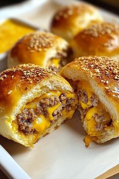 cheeseburger sliders cut in half on a plate