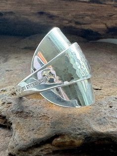 a silver ring sitting on top of a rock