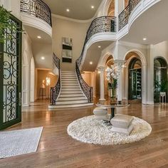 a large open floor plan with stairs and chandelier in the middle of it