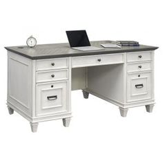 an office desk with two drawers and a laptop