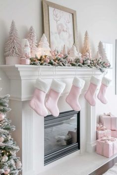 christmas stockings hanging from the mantel in front of a fireplace decorated with pink and white ornaments