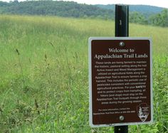 a sign in the middle of a field that says welcome to appalachan trail lands