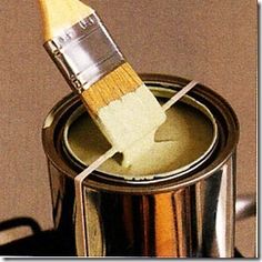 a paint can with a brush in it