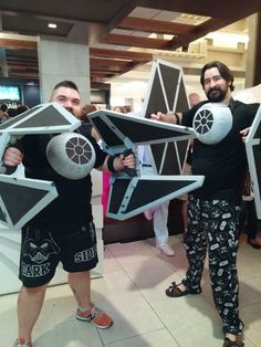 two men in star wars costumes standing next to each other