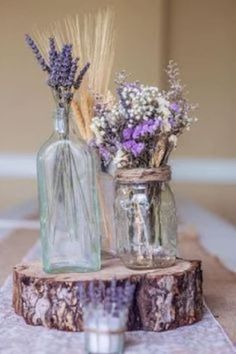 two vases filled with flowers sitting on top of a table