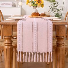 a table topped with a vase filled with yellow flowers