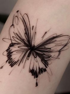 a black and white butterfly tattoo on the leg