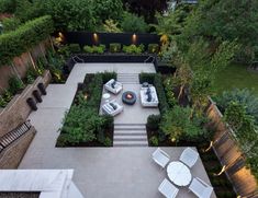 an aerial view of a backyard with seating and trees in the back yard, surrounded by greenery