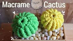 two crocheted flowers sitting in a box on top of some white and yellow rocks